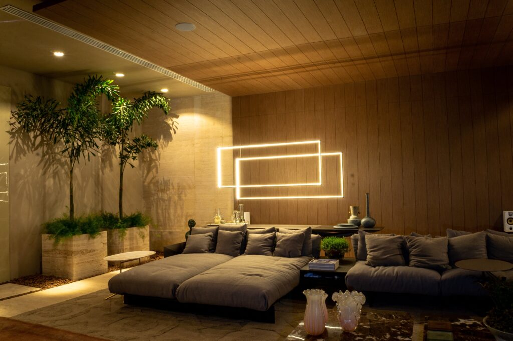 Modern living room interior with cozy sofas and shiny lamps