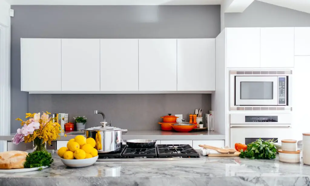 Kitchen area with white cabinets