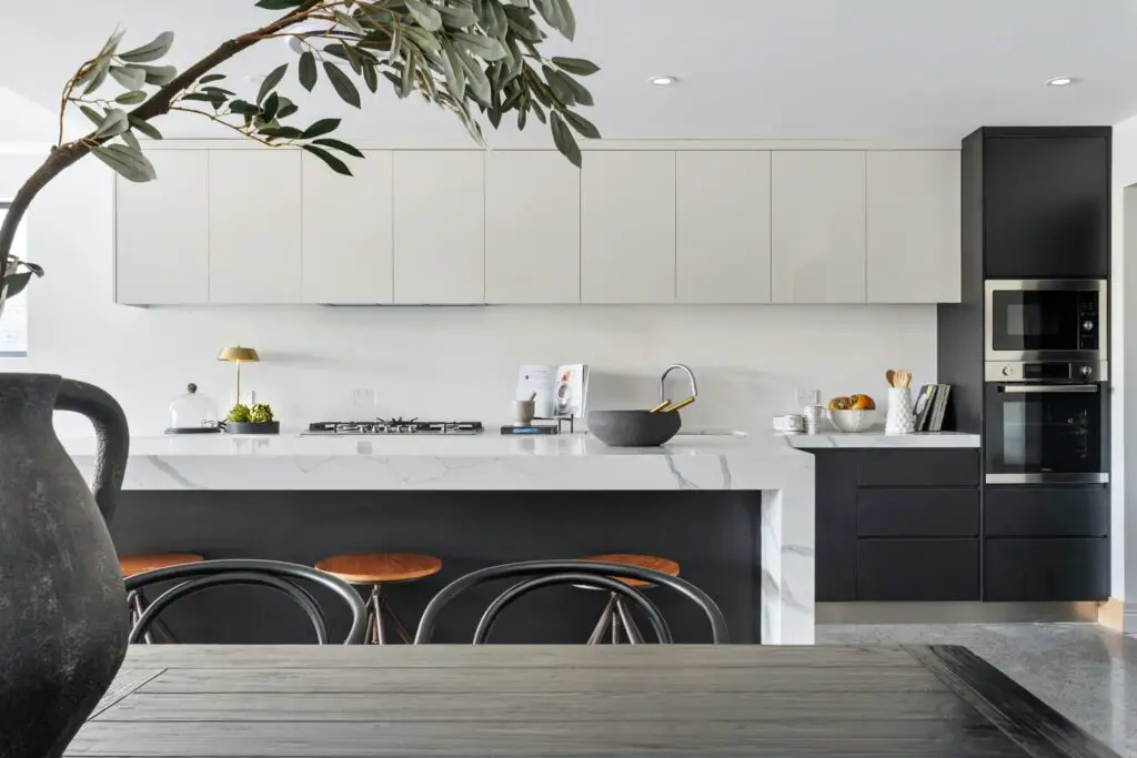 Kitchen area with black and white toned cabinets