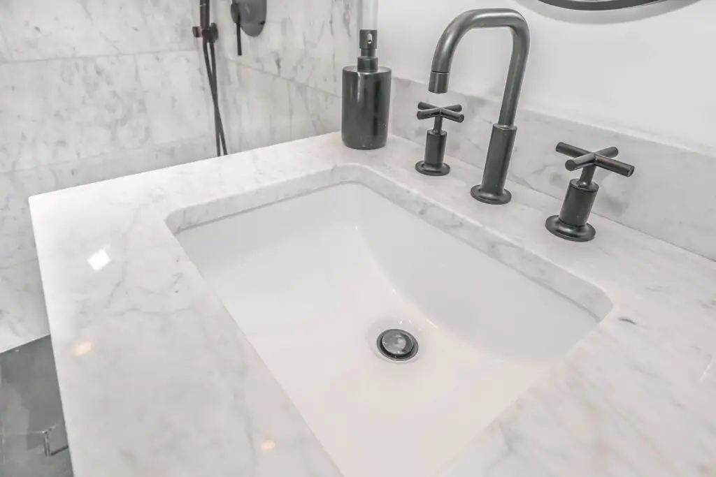 A close up shot of a white toned sink