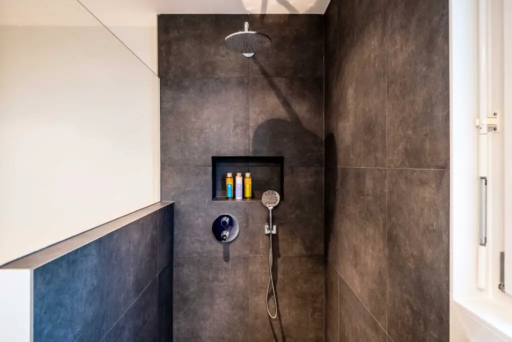 A walk in shower with glass