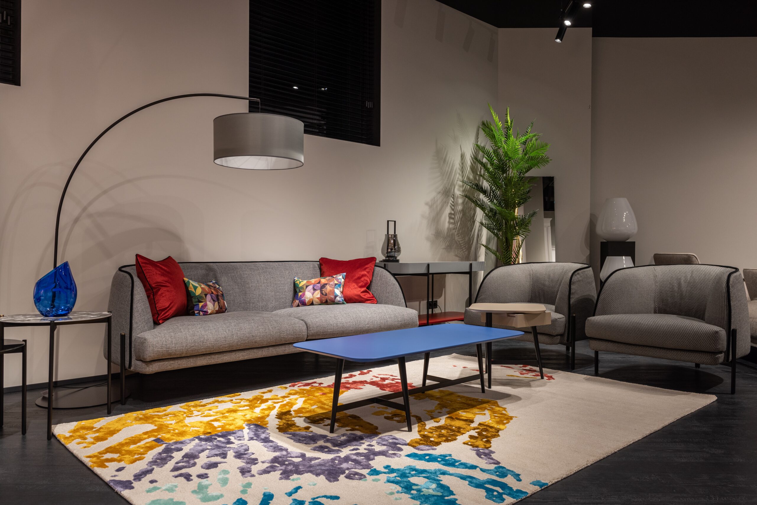 A gray toned furniture with a floor lamp