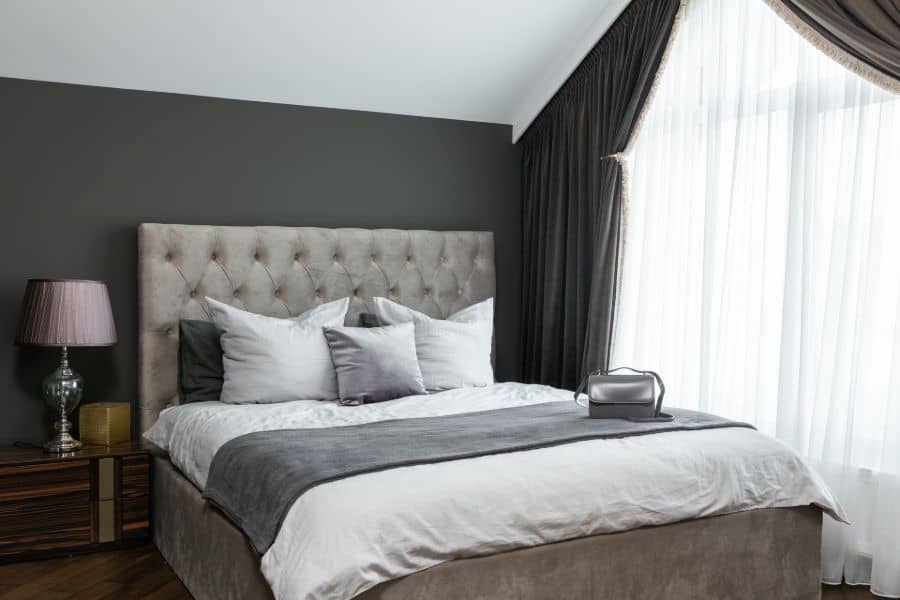 Bed with white and gray sheet and pillows