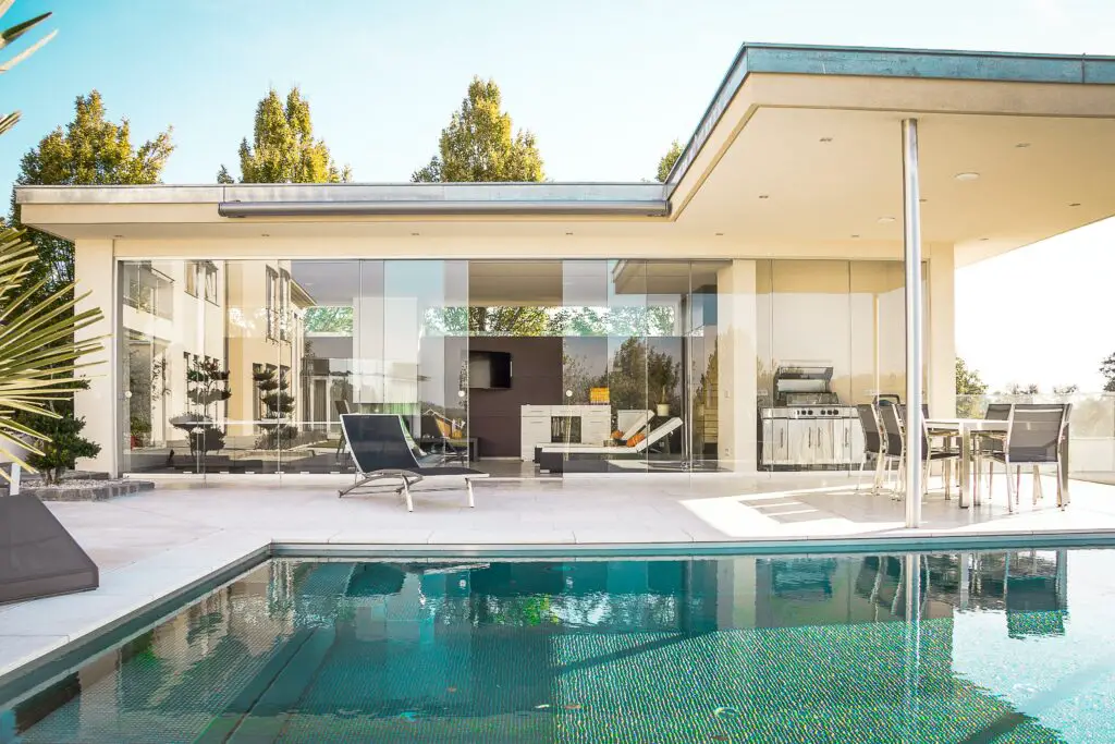 Outdoor swimming pool with chairs and a table