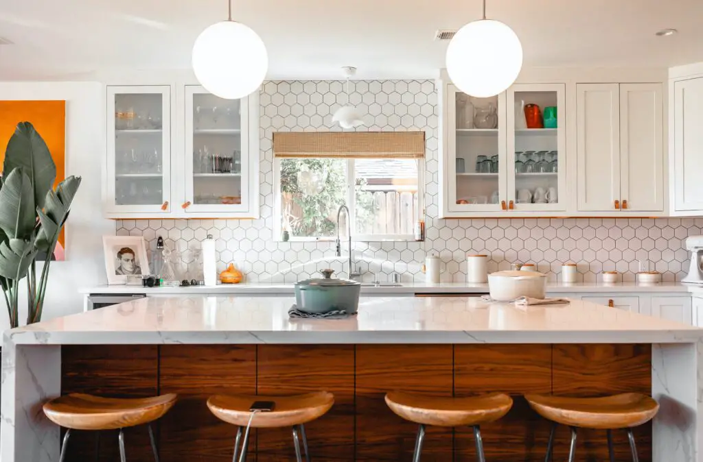 kitchen area with wooden chairs and glass cabinets 