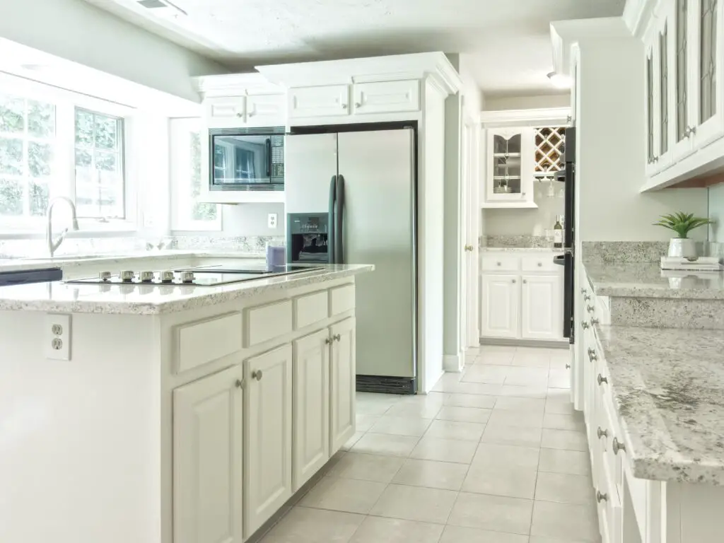 a white toned kitchen area with cabinets