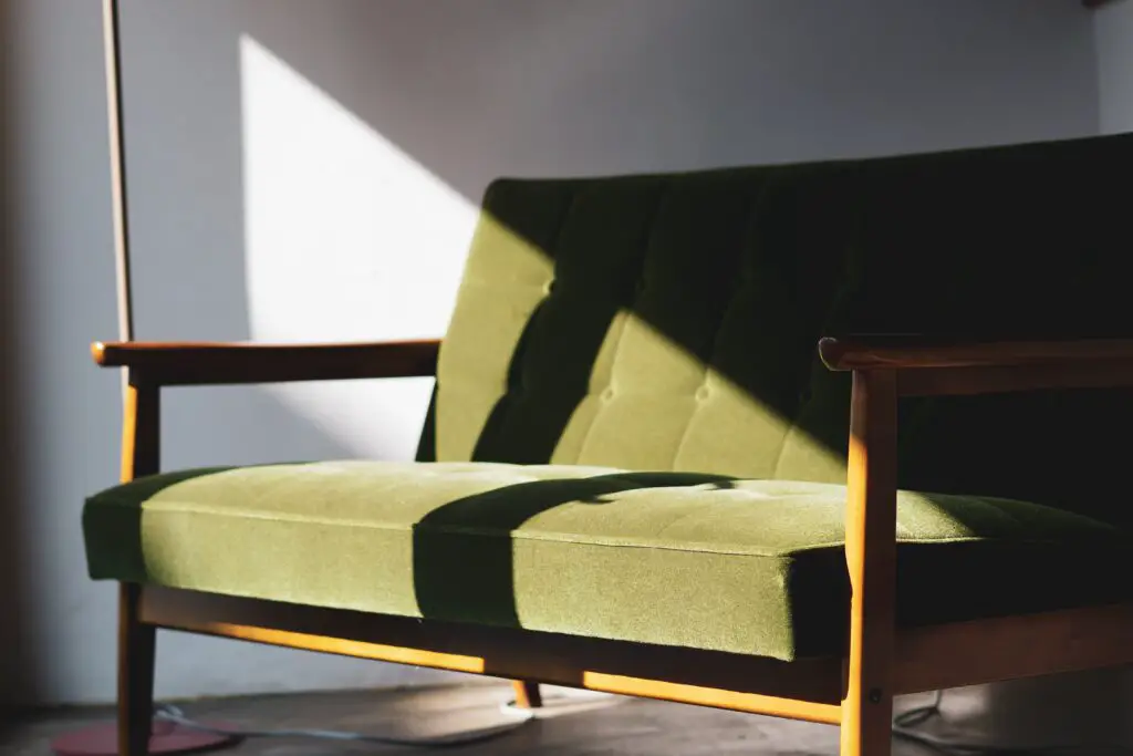 A long green chair with sunlight