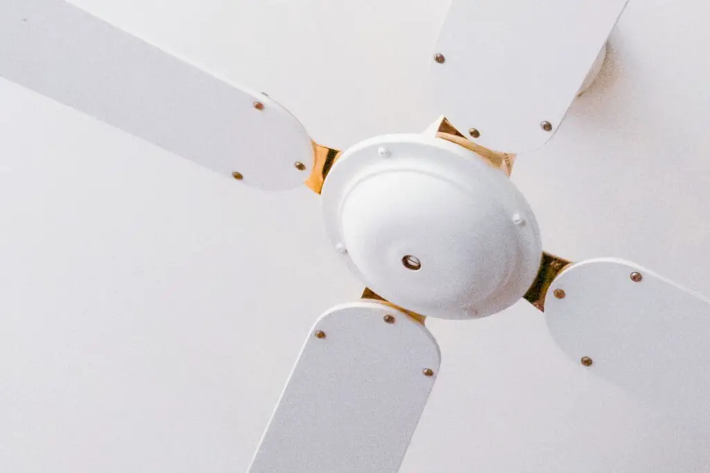 A close up shot of a white ceiling fan