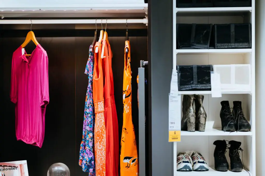 A closet with a few clothes and shoes