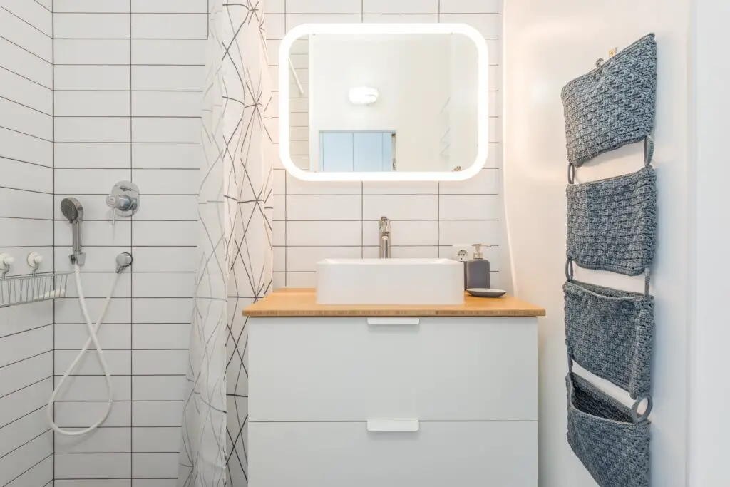 Vanity bathroom with cabinets and lights in the mirror