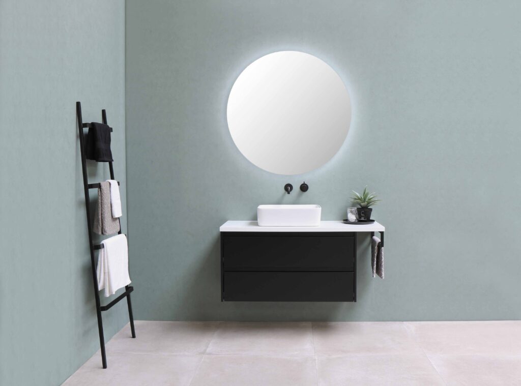 Vanity bathroom with round mirror and sink