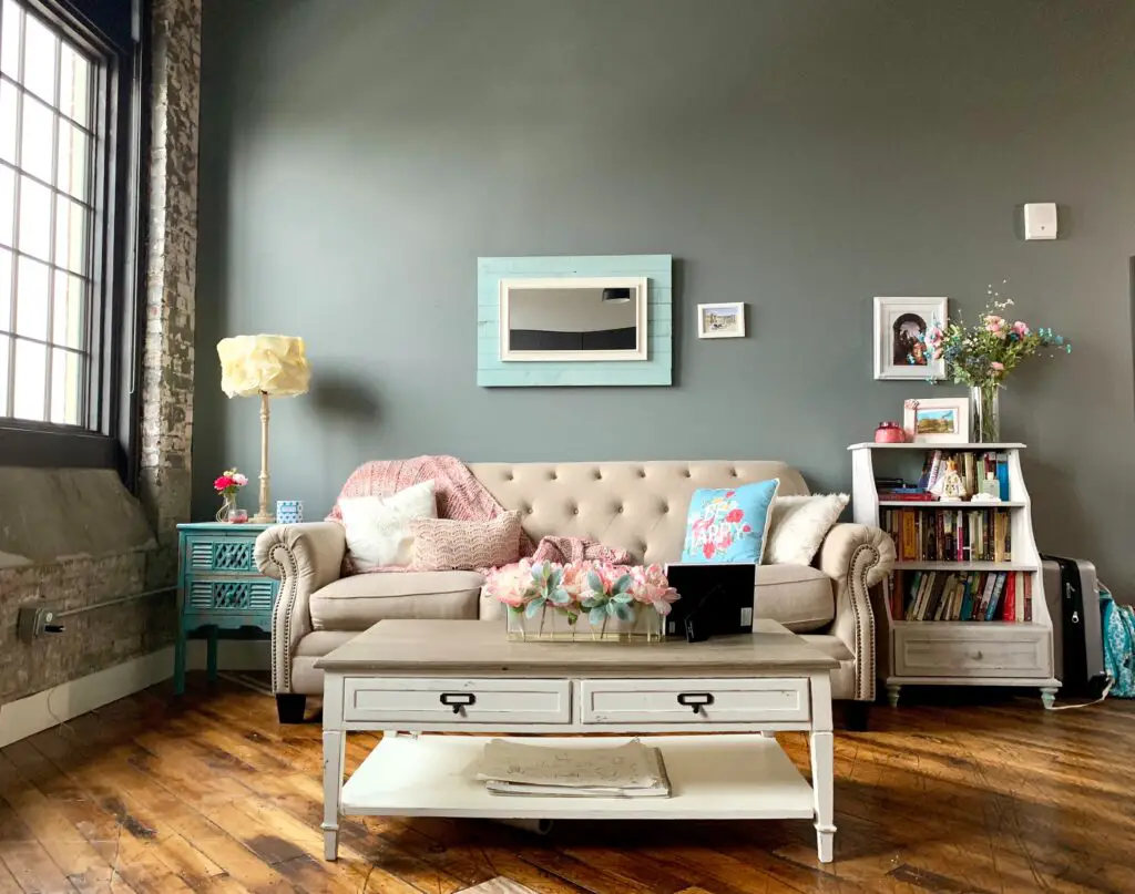 A living room with a sofa and a painting
