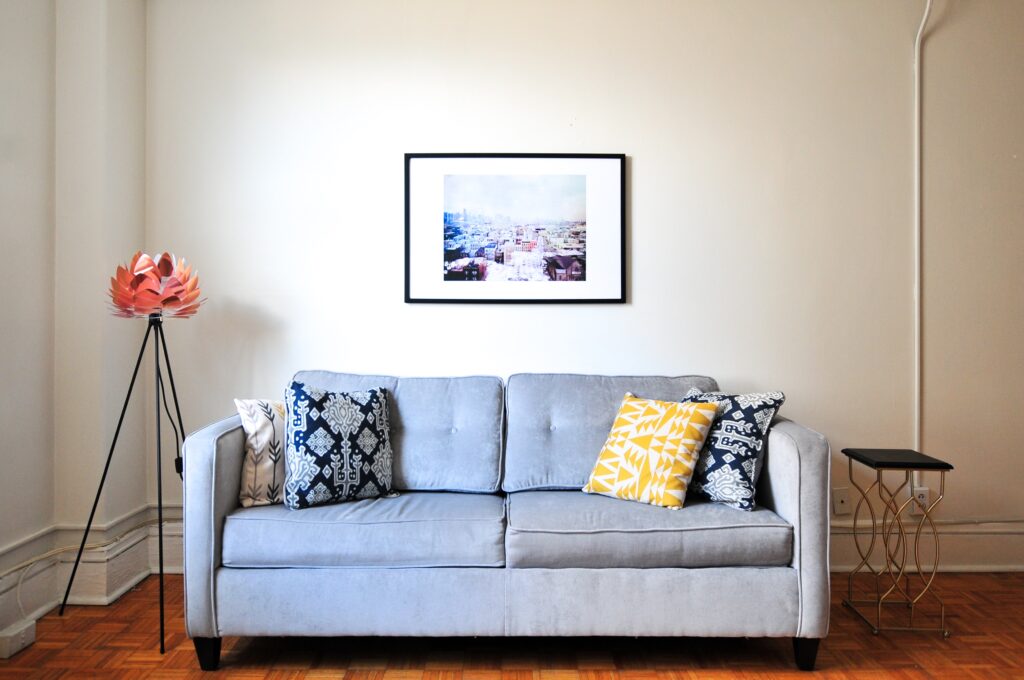 A sofa with pillows and a painting