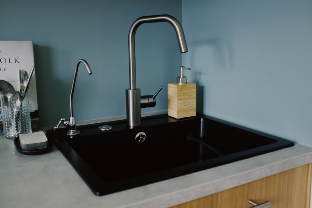a black sink with a silver faucet