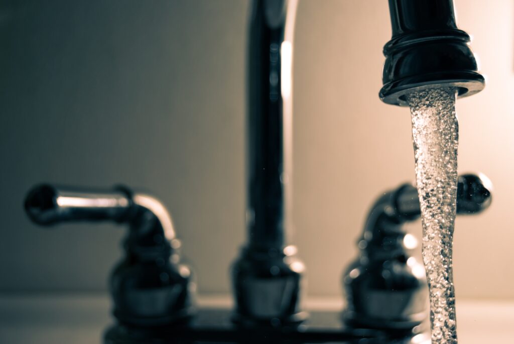 Close up shot of a faucet with running water