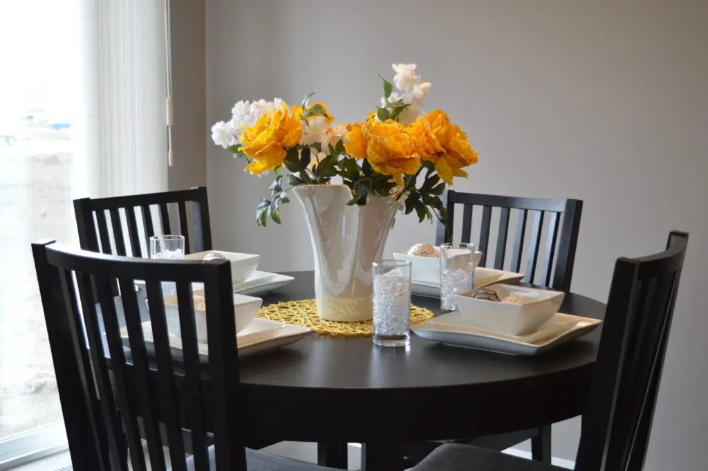 A dinner table with flowers on the center