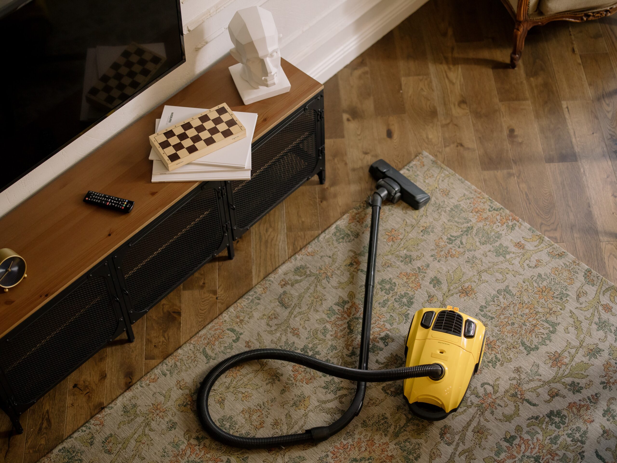 Yellow Vacuum cleaner on the carpet