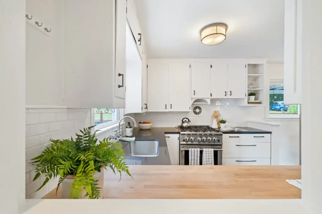 A kitchen area with a sink near the window