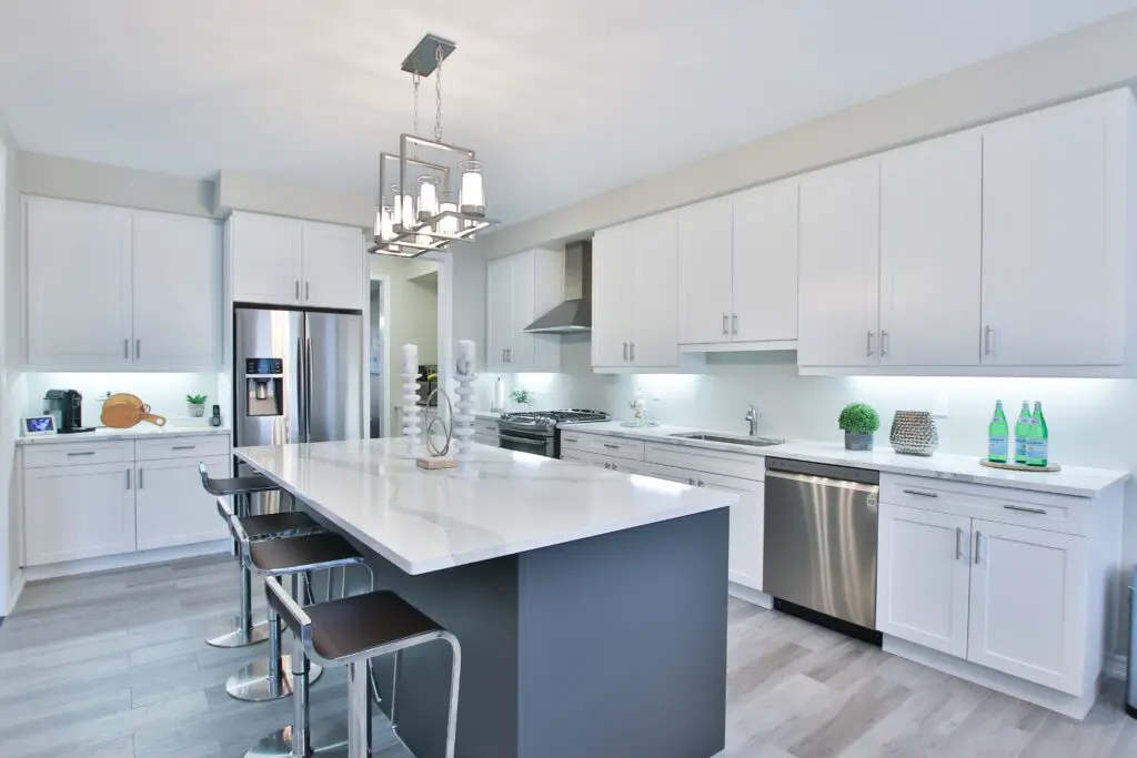 A white toned kitchen area with cabinets