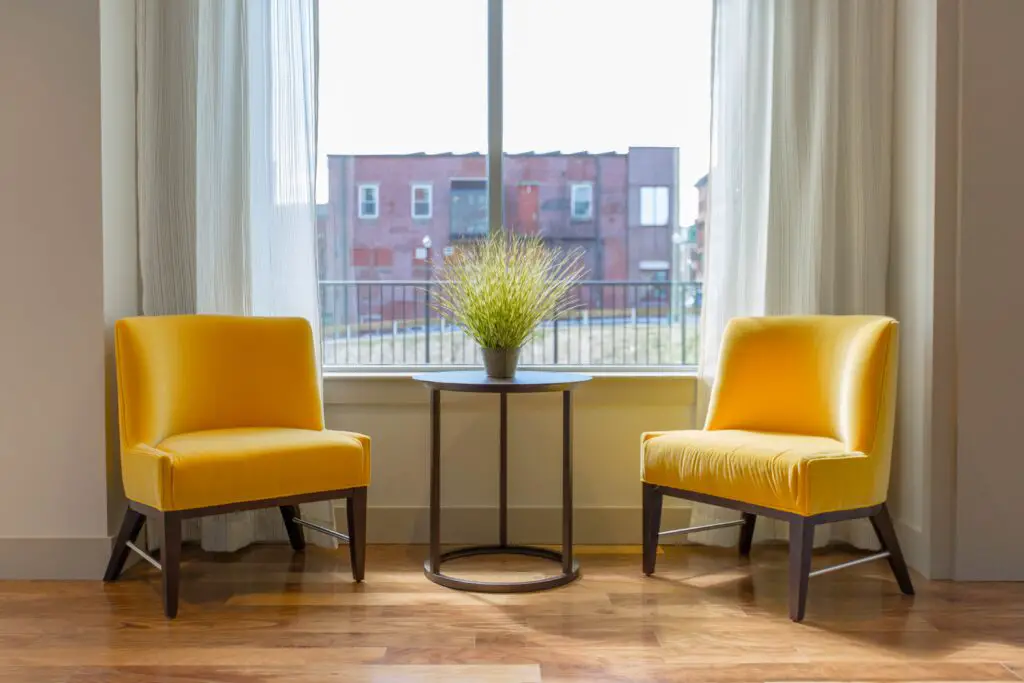 Two yellow chairs near the window