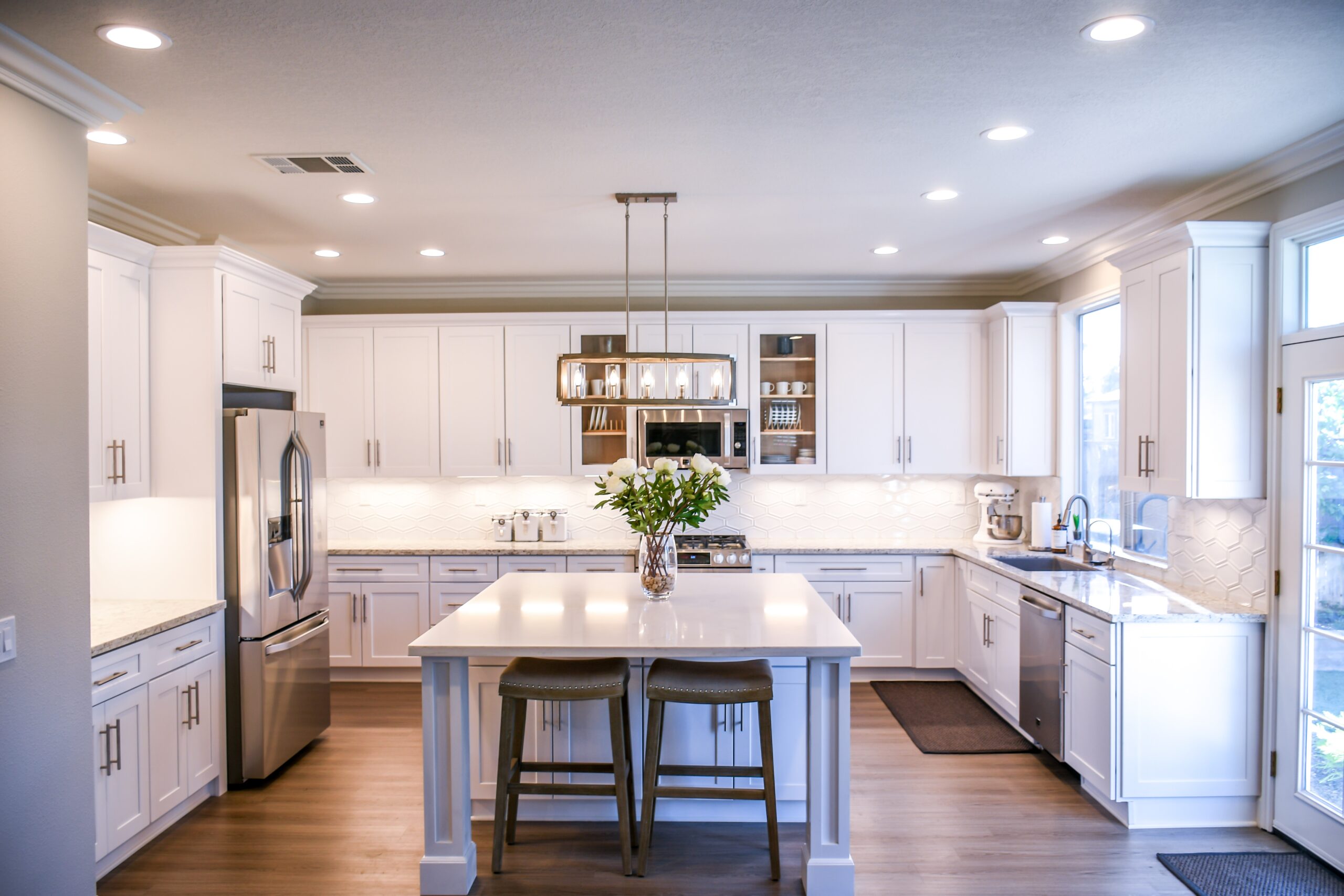 A white toned kitchen area with cabinets