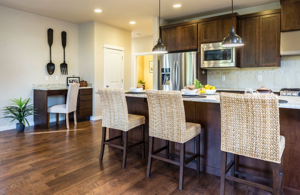 A kitchen and dining area with chairs and cabinets