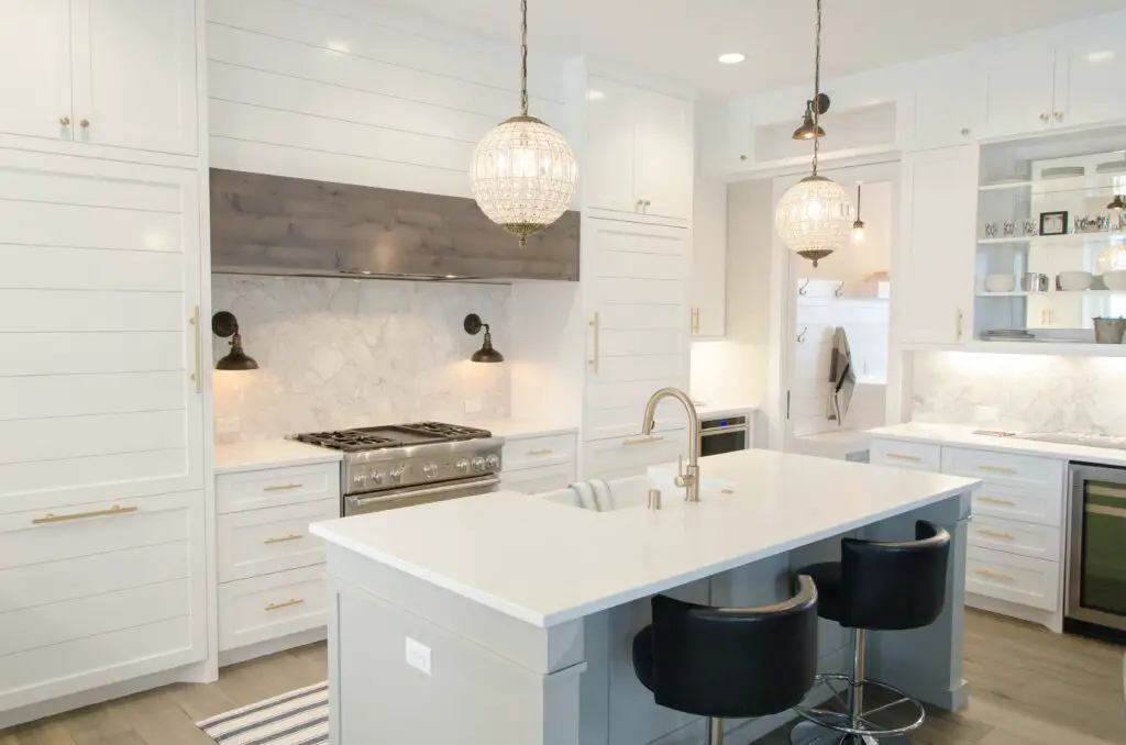 A white toned kitchen and dining area