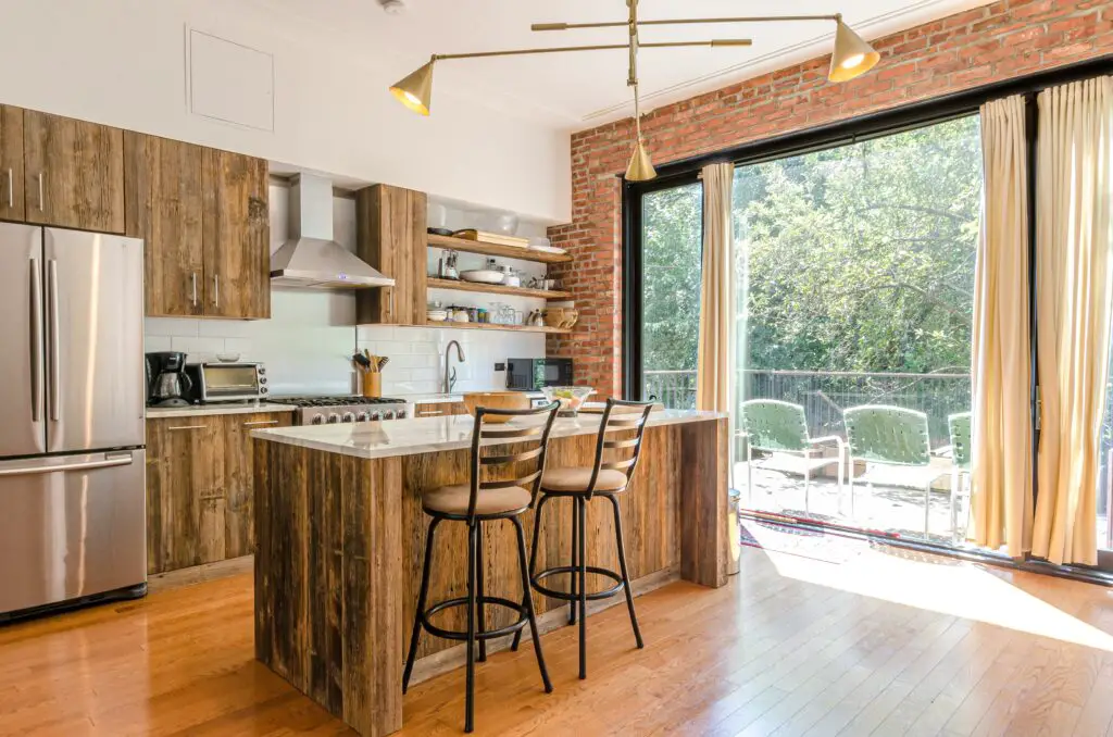 A kitchen and dining area with wood cabinets