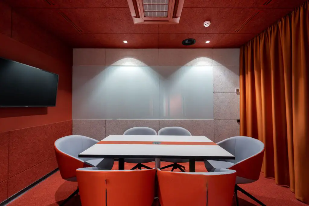 Womb chairs with a center table and red walls