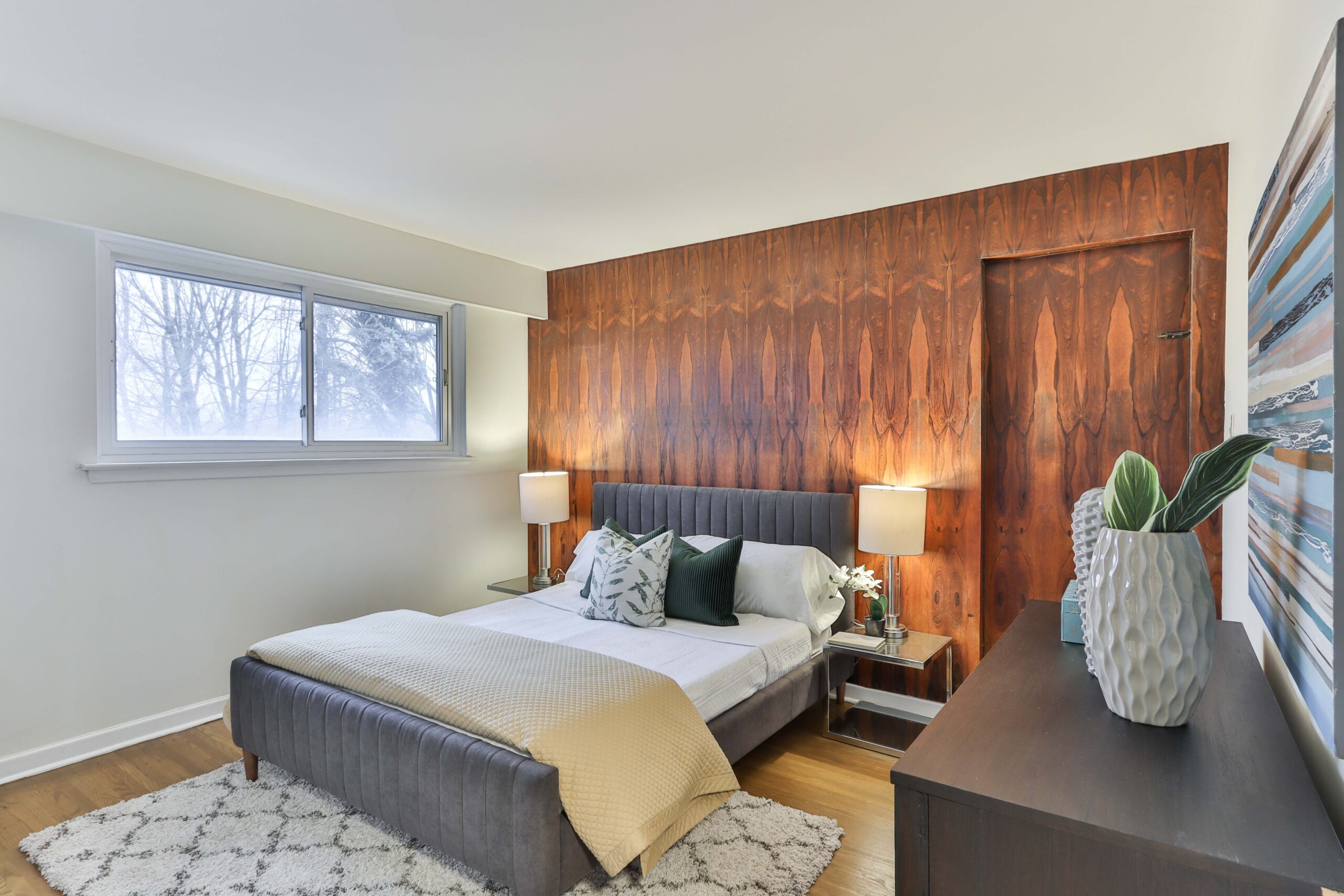A bedroom with brown toned wallpapers on a wall