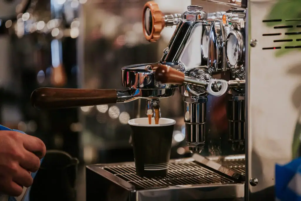 A coffee machine pouring coffee to cup