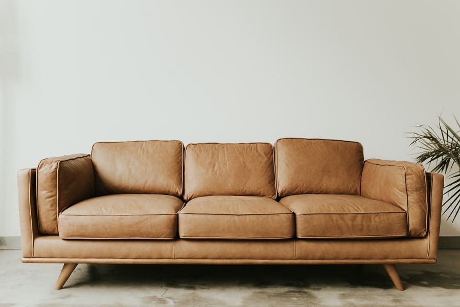 A three-seater brown leather couch