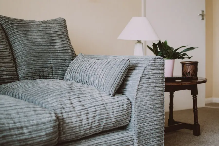 A living room couch with corduroy fabric