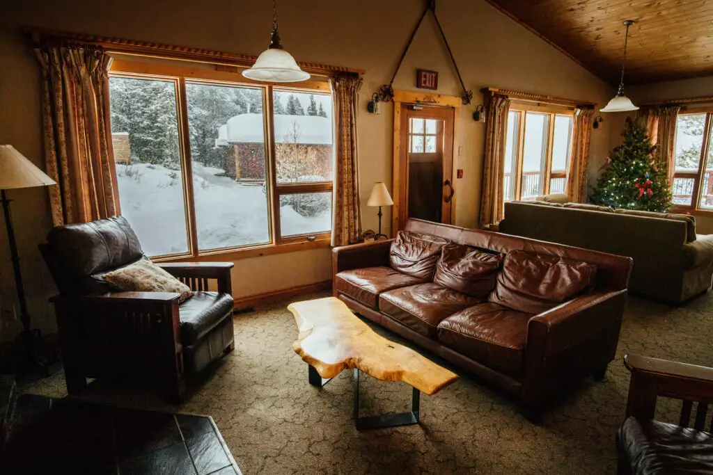 A brown toned living room with sagging leather couch