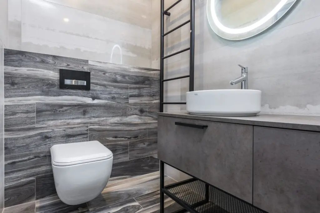 A bathroom with white ceramic sink and toilet
