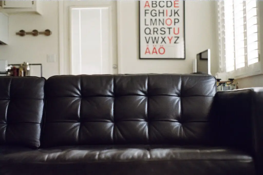 A black leather couch in a living room