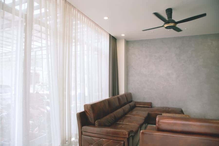 Room with white curtain and brown couch