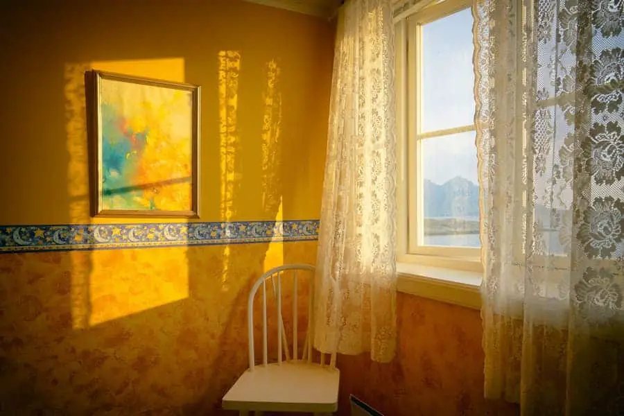 Room with white curtains and yellow wall