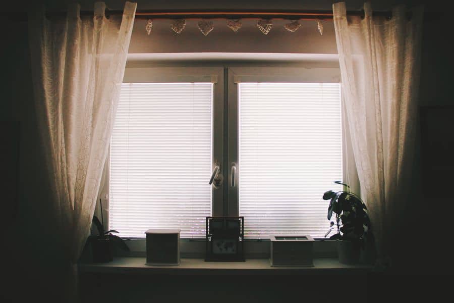 French curtain rod attached with curtains, installed in a home window