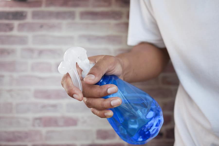 A person holding a vinegar solution