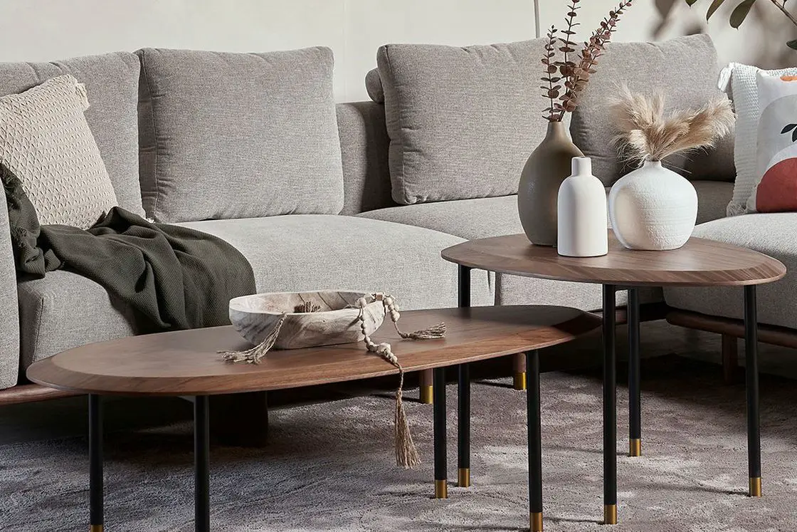 Gray sectional sofa with a two piece wooden center table