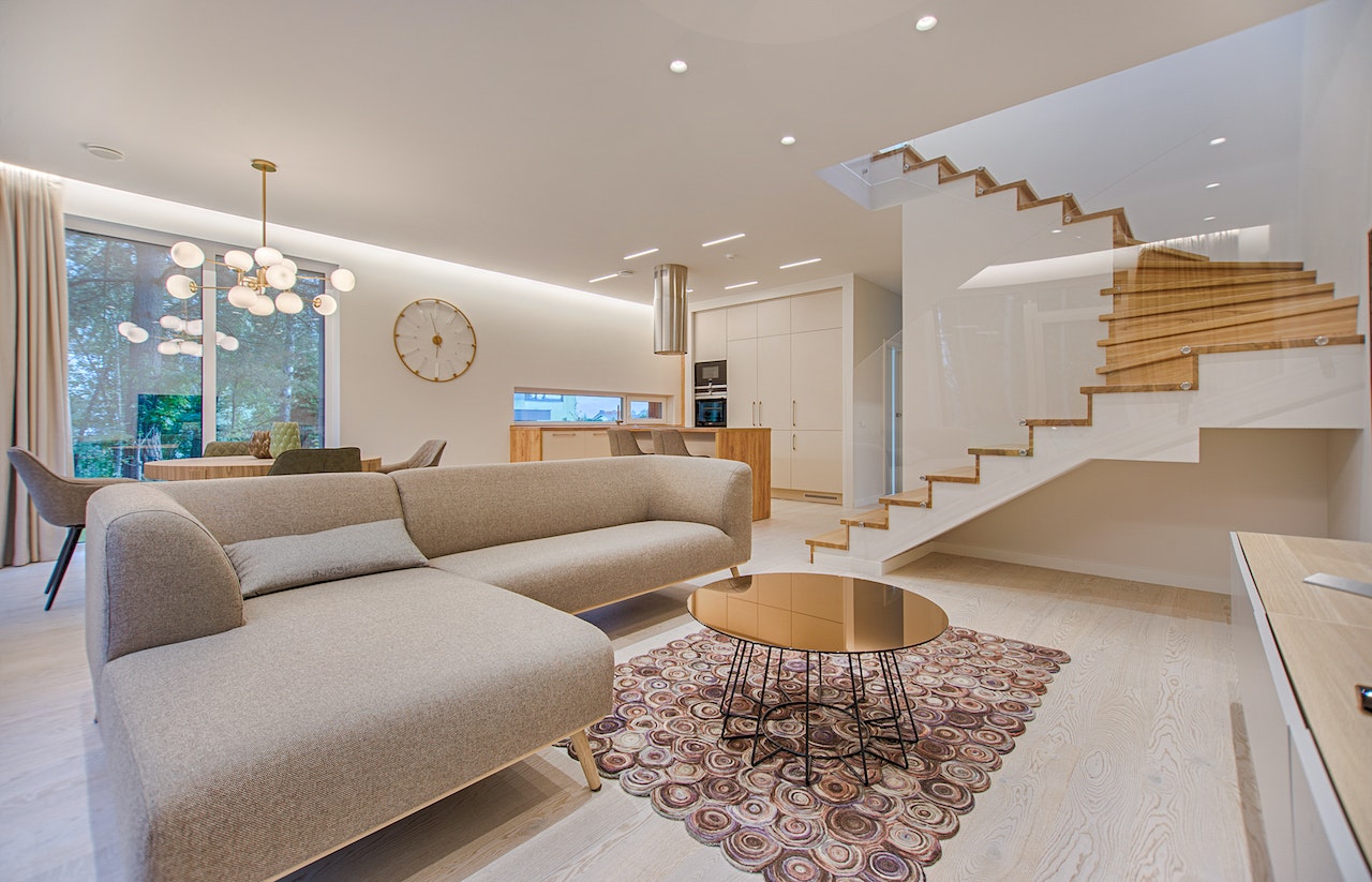 Brown sectional sofa and a round table are placed in the living room