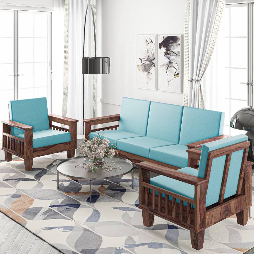 A brown wooden sofa set with blue cushions and a stainless center table