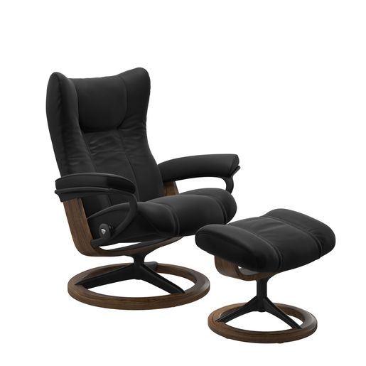 A black and brown Stressless recliner with brown and black foot rest